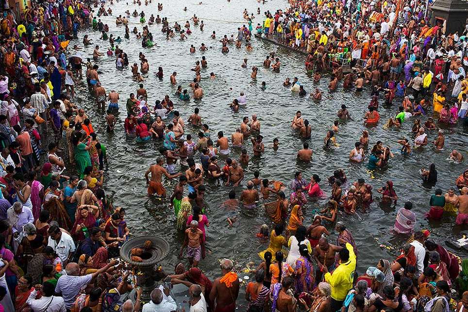 Sadhus of different sects surround one of their leaders at a holy ...